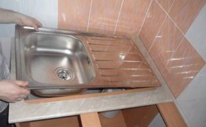 How to install a stainless steel sink on a cabinet.