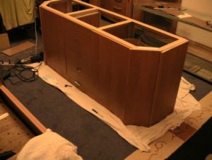 The process of making a special cabinet for an aquarium.