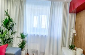 White curtains in the bedroom interior