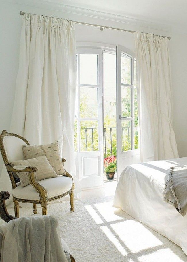 White curtains in the bedroom interior