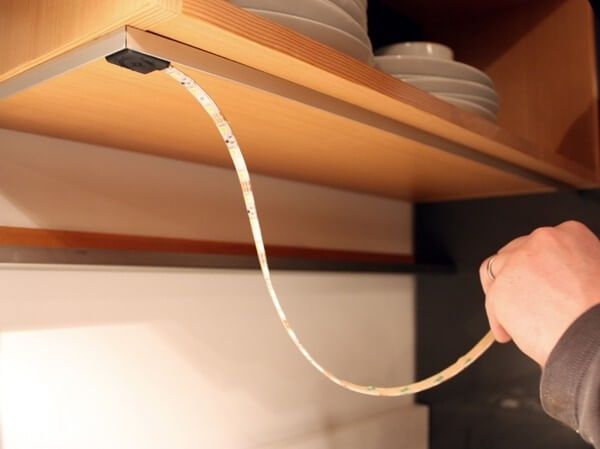 Glue the LED strip to the kitchen unit