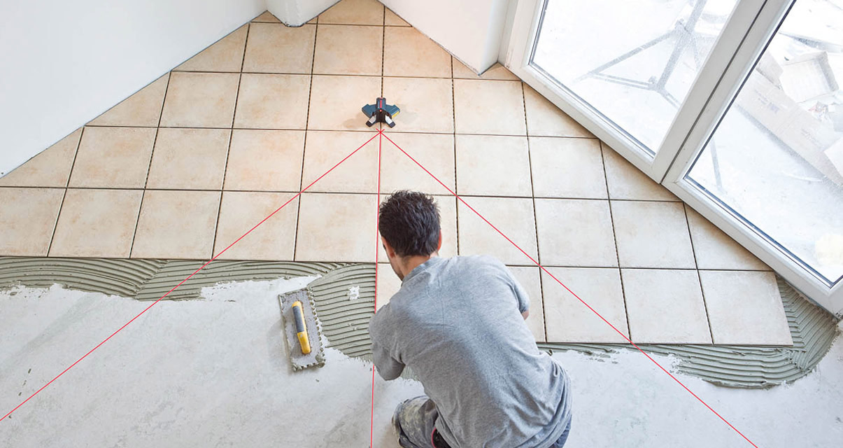 Laying tiles in the kitchen.