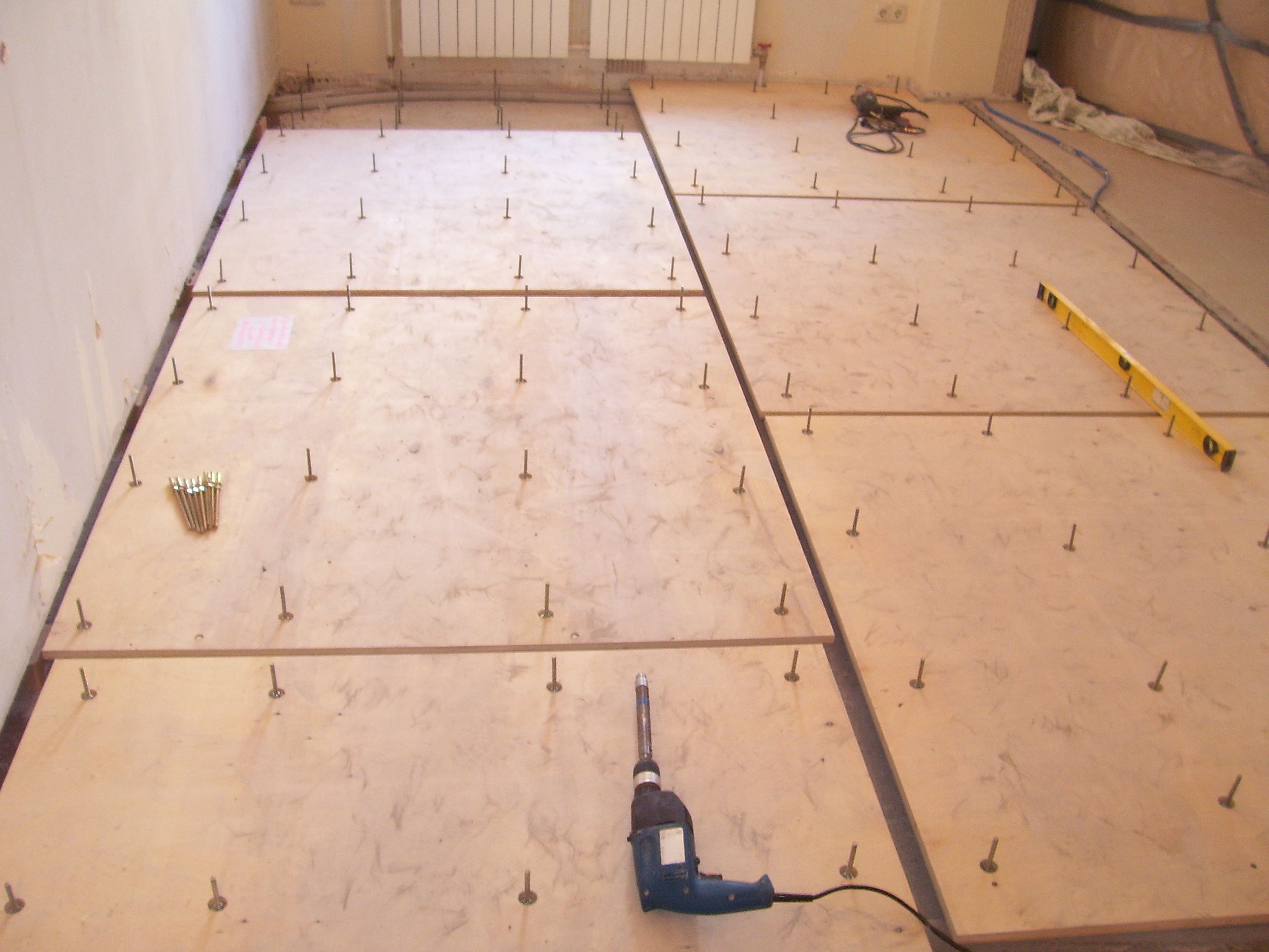 Laying plywood on a concrete floor