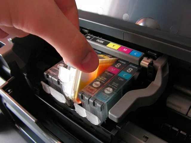 Visually checking the ink level in an inkjet printer.