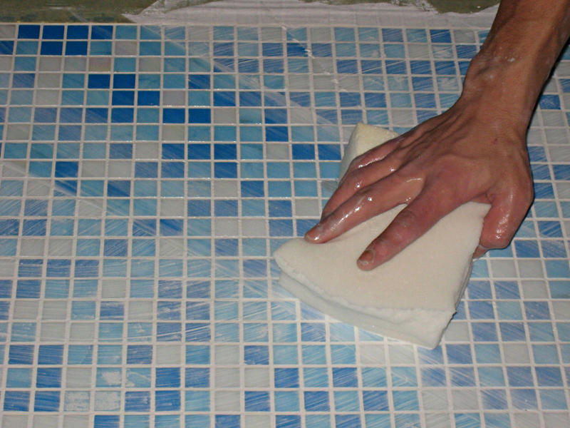 Washing tile floors.