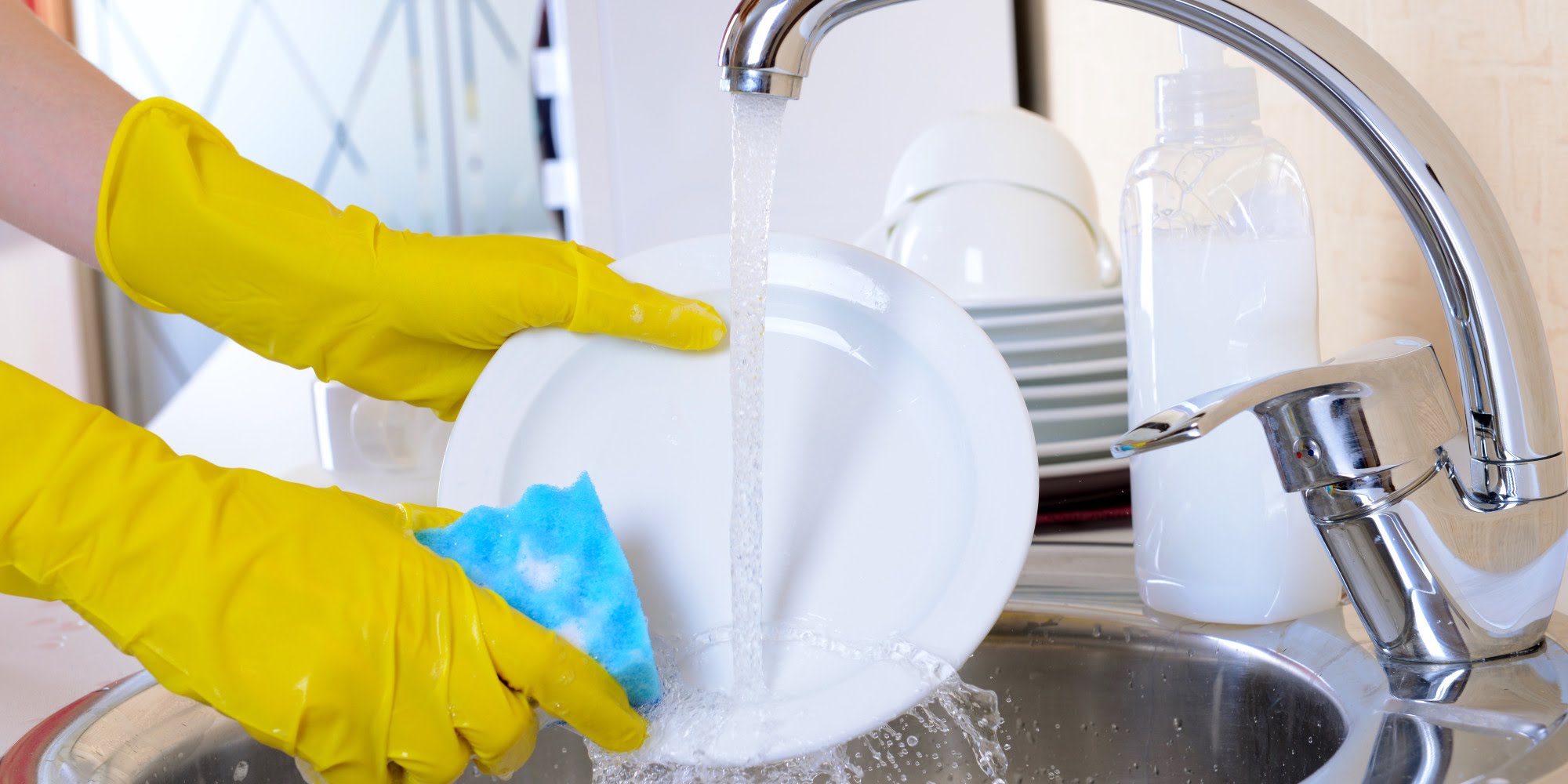 Washing dishes with gloves.