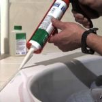 Application of silicone sealant.