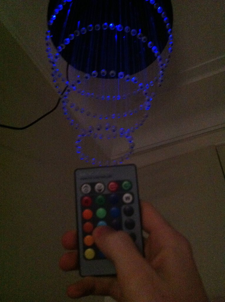 We control the chandelier using the remote control.