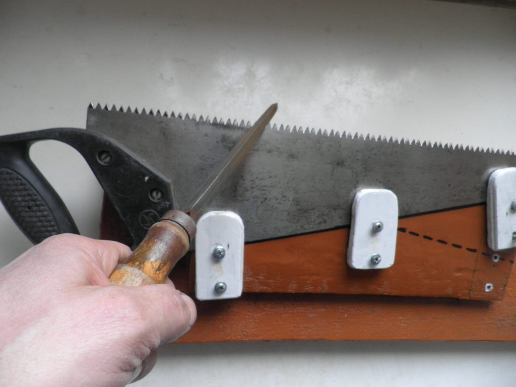 Sharpening a hacksaw.