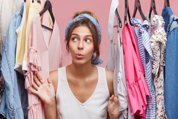 Placing clean clothes in the closet