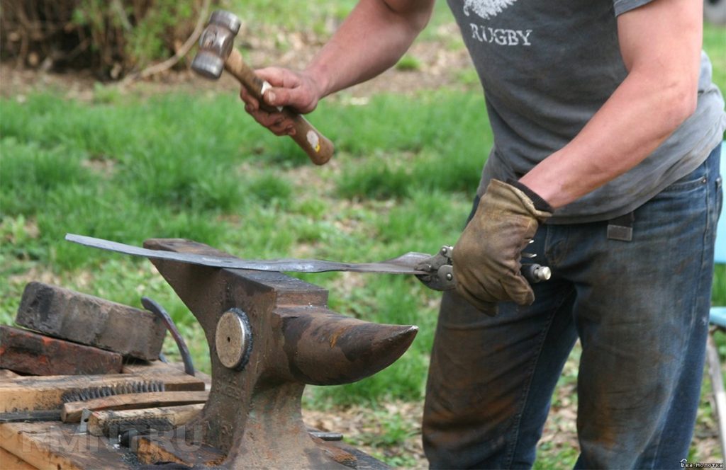 Adjusting the lawn mower blade.