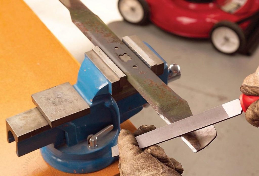 Sharpening a lawn mower blade.