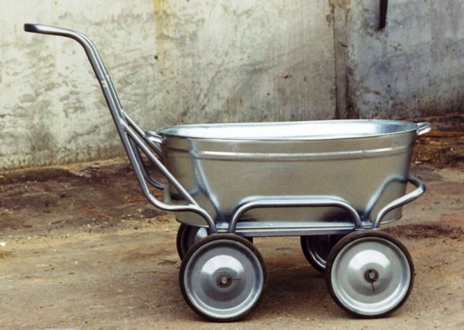 A wheelbarrow made from a trough on four wheels.