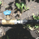 The hose is connected to a metal pipe.